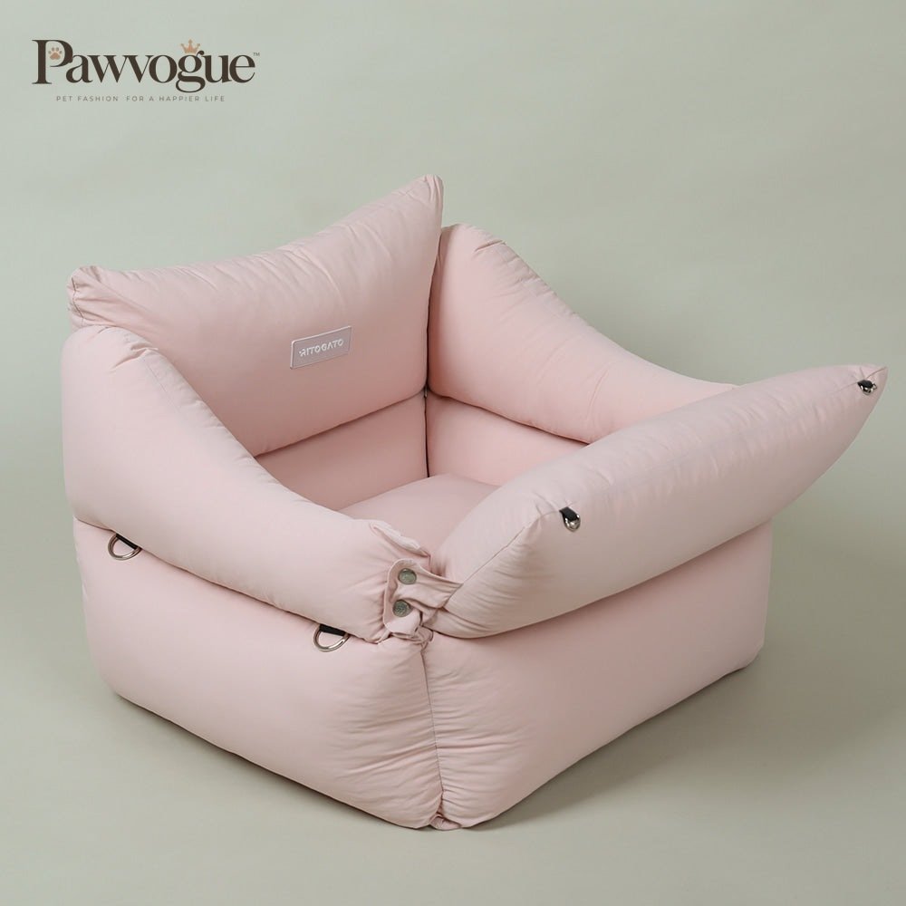 Pink car seat on a light green background
